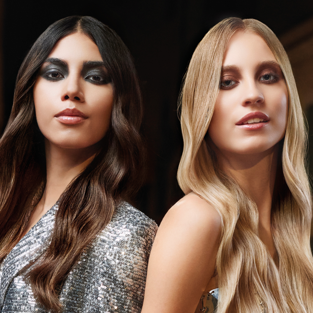 immagine di due ragazze, a sinistra una mora con capelli lunghie e a destra una bionda con capelli lunghi